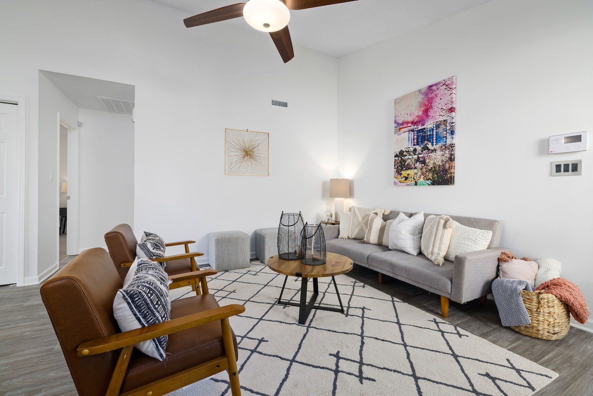 A Living Room with A Couch , Chairs , and A Ceiling Fan — Kelwin Coastal Carpets In Kundra Park, QLD