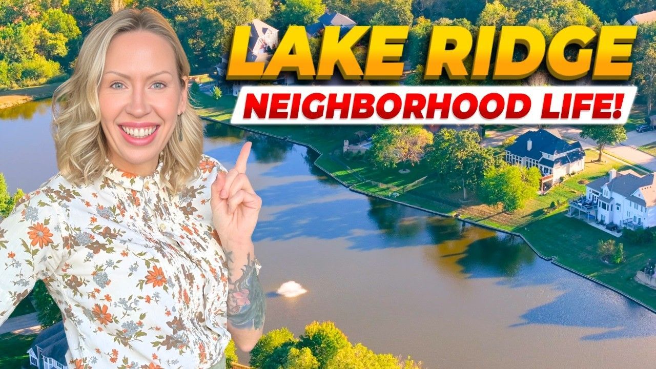 A smiling person points toward a lake and houses in a residential neighborhood, with 
