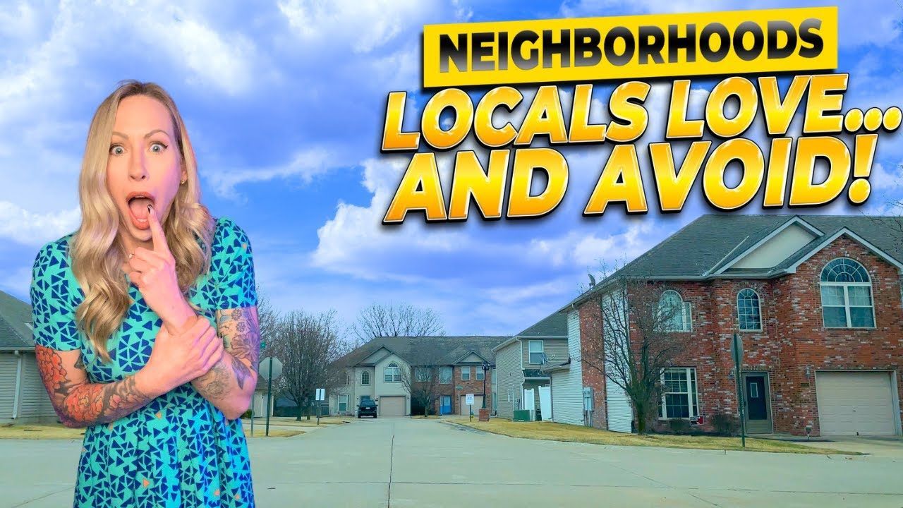 A woman in a crop top is standing in front of a residential area.