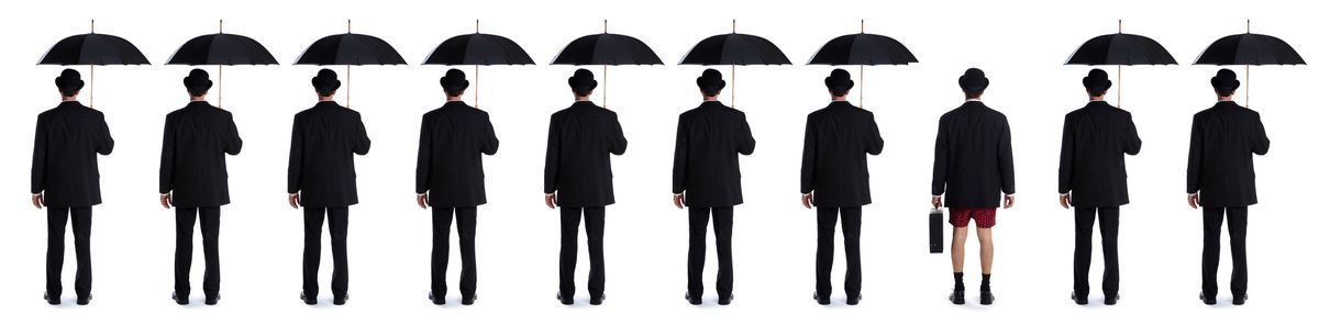 Image of men with umbrellas and one man without pants