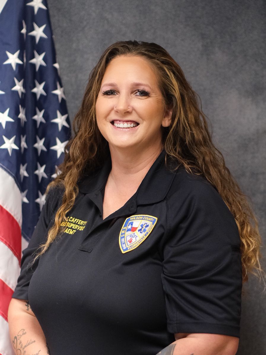 A woman wearing a black shirt with a badge on it