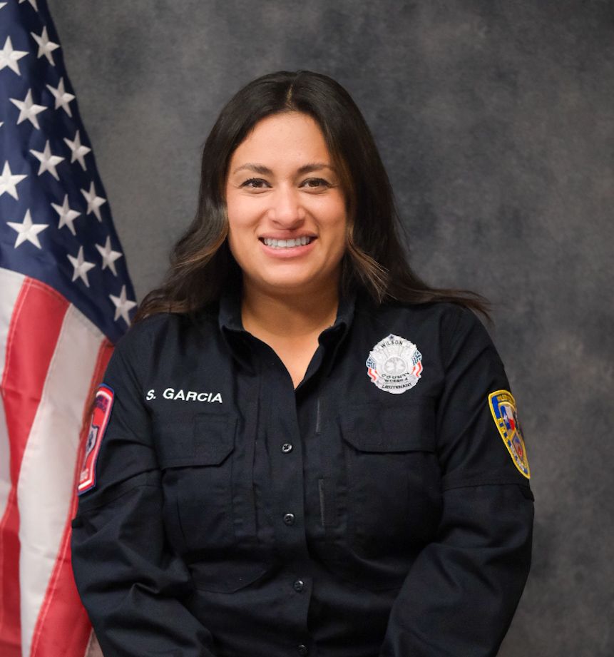 A woman wearing a blue shirt with the name garcia on it