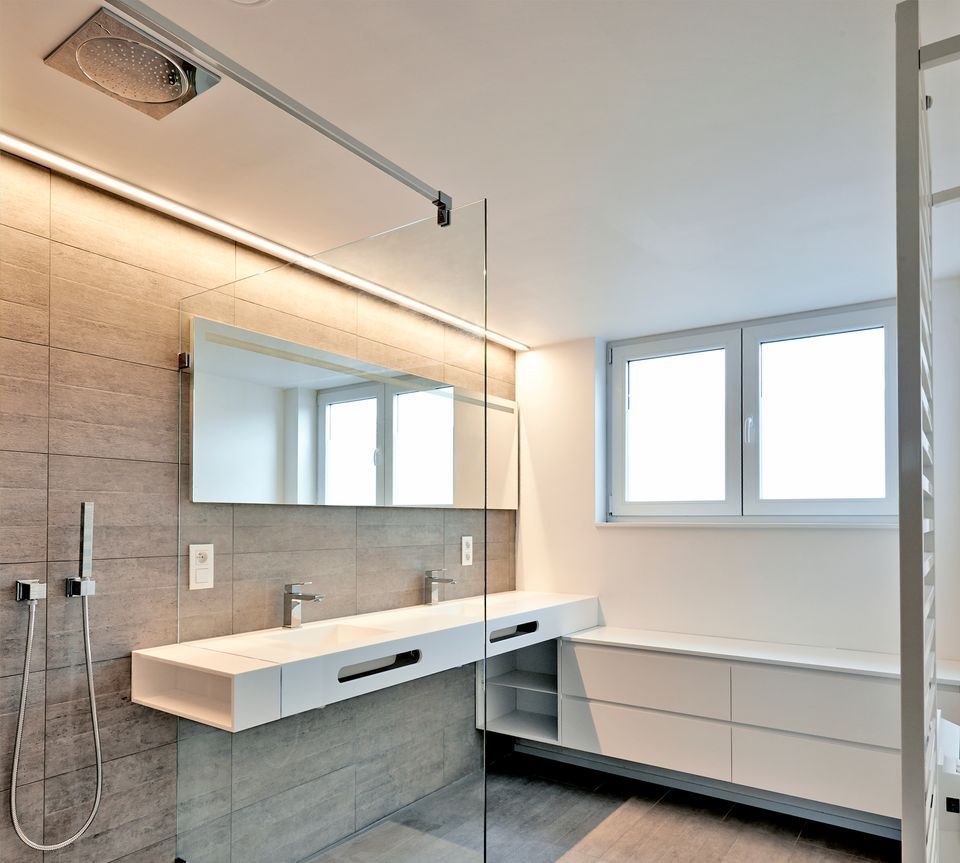 A bathroom with two sinks and a shower