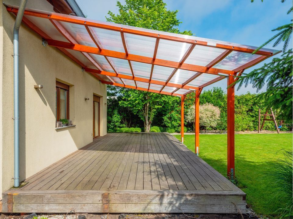 There is a wooden deck with a canopy over it.