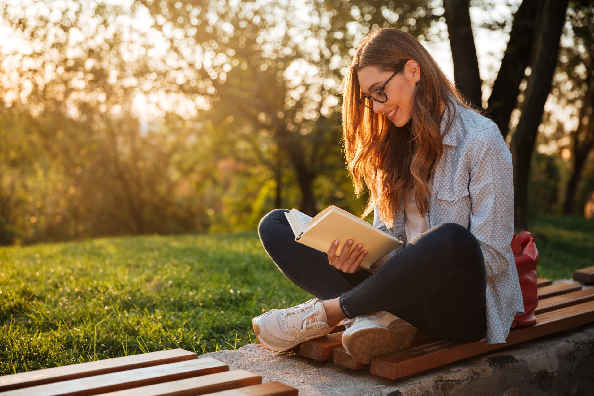 Woman Reading Book In Park