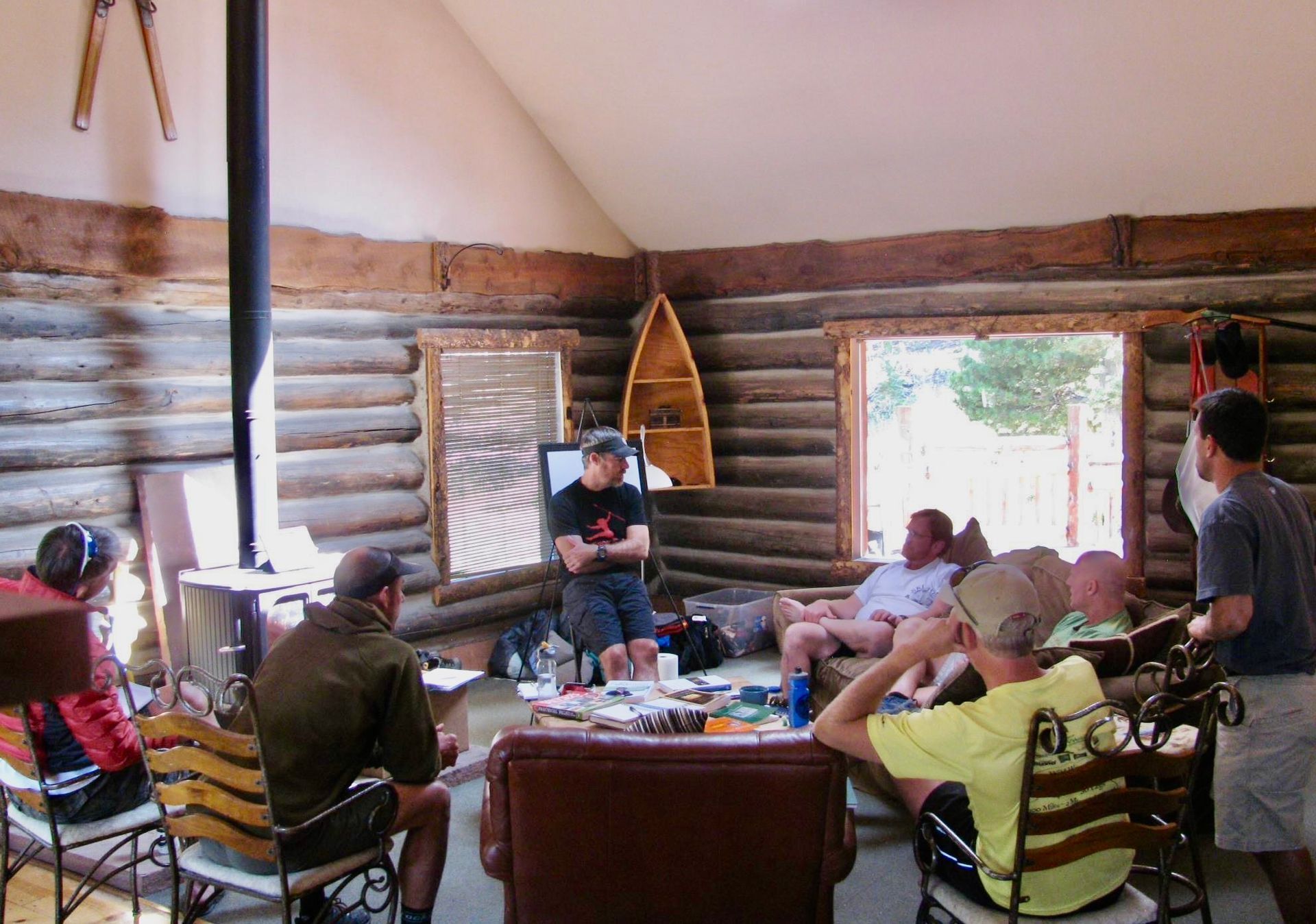 A small green seedling growing out of a pile of dark brown soil.
