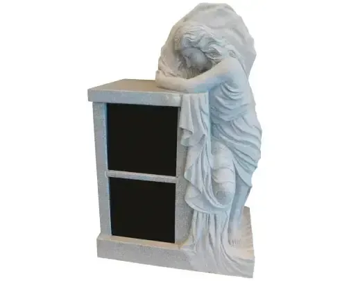 White stone memorial with weeping angel statue beside a black-doored niche for cremains.