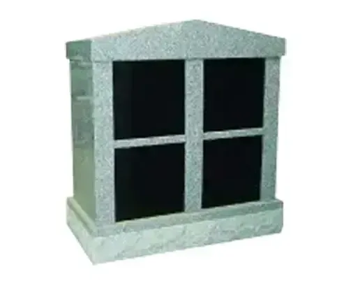 A granite columbarium with four black niches.