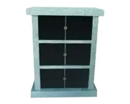 Gray columbarium with black niches for storing cremated remains.
