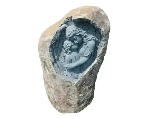 Stone sculpture of an angel embracing a child within a carved-out niche.