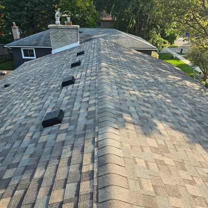 The roof of a house with a chimney on top of it.