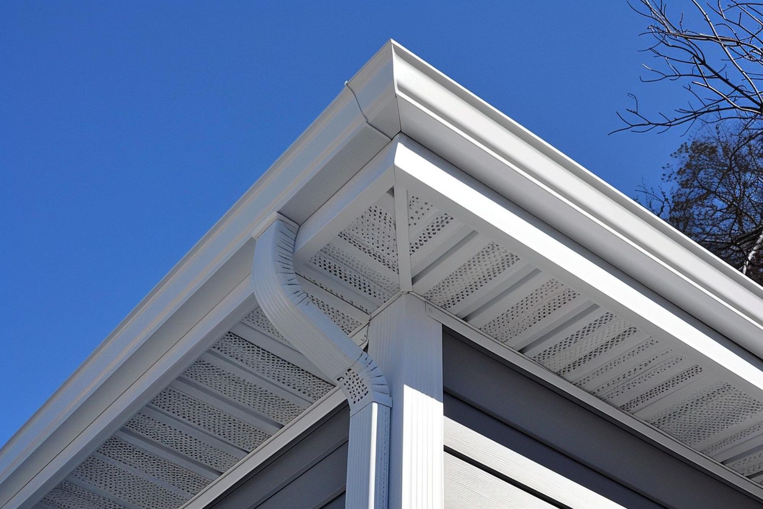 A white gutter on the side of a house