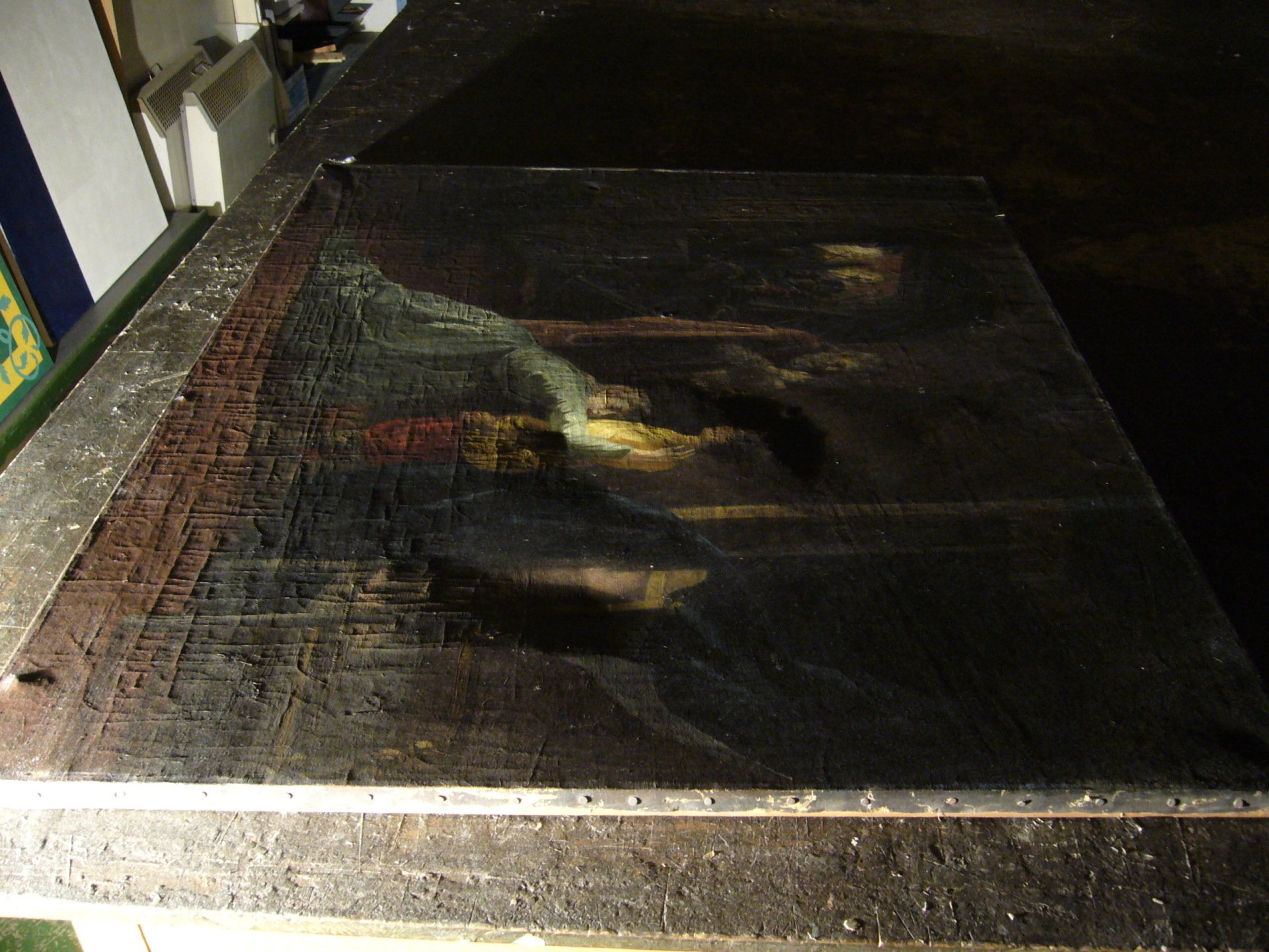 Poor canvas surface before treatment shown in raking light