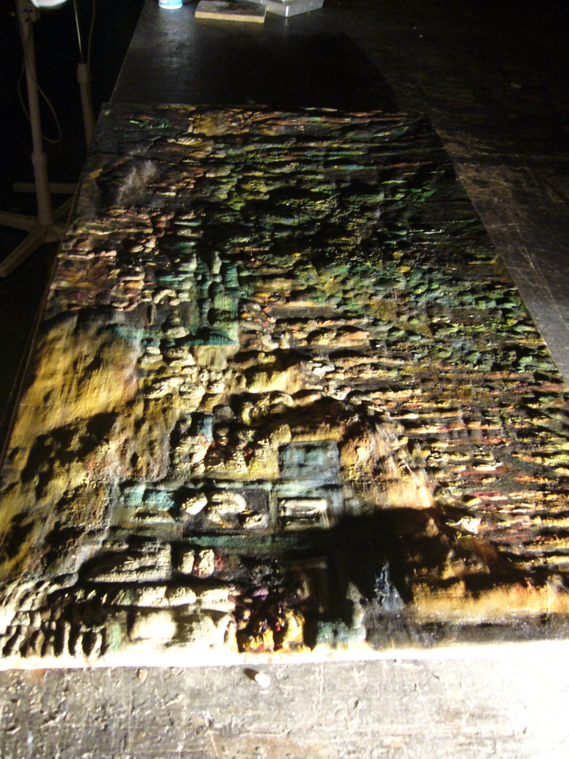 Fire damaged blistering and bubbling paint and canvas shown with raking light