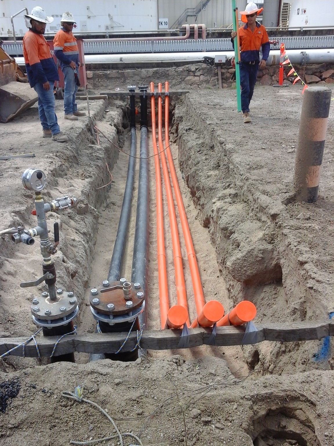 Civil Plumbing Pipes and Workman Holding Pipe - Plumber in Mount Low, QLD