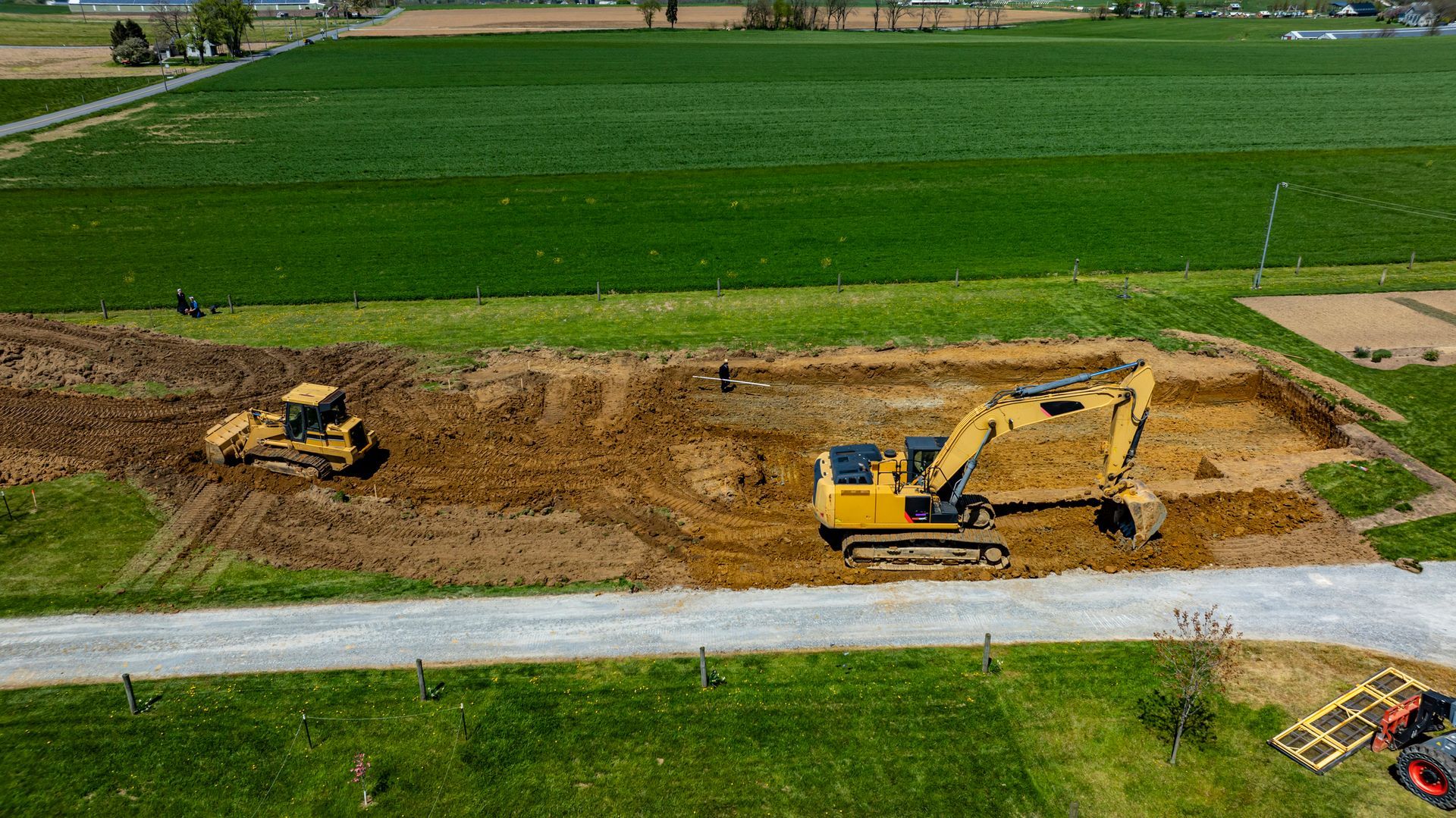 An aerial view of a construction site with tractors and excavators.