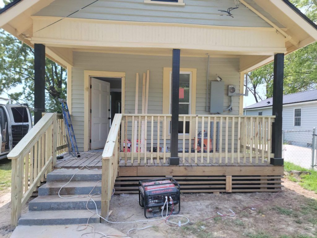 A Small House With a Porch and Stairs is Being Remodeled