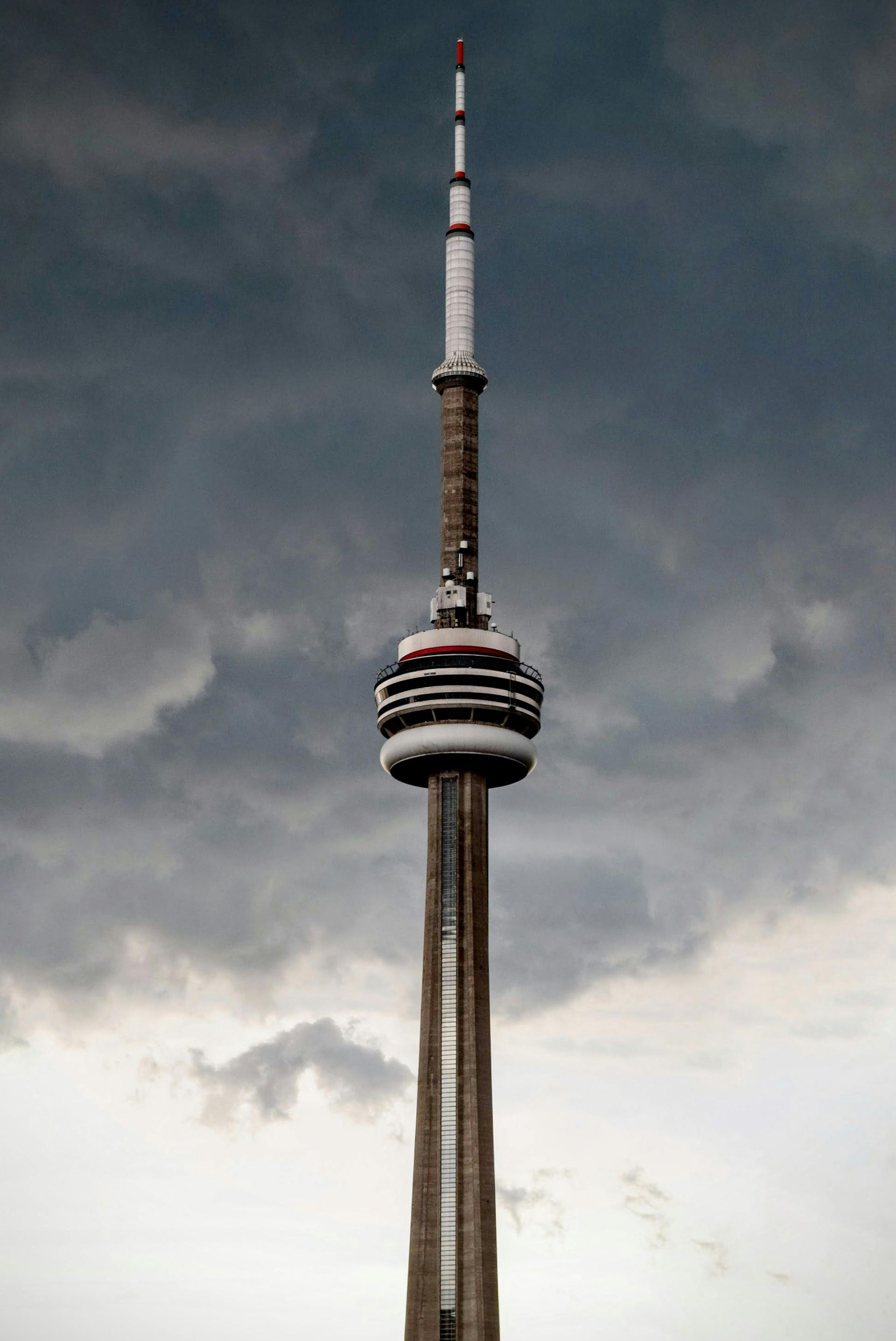 A tall tower with a cloudy sky in the background.