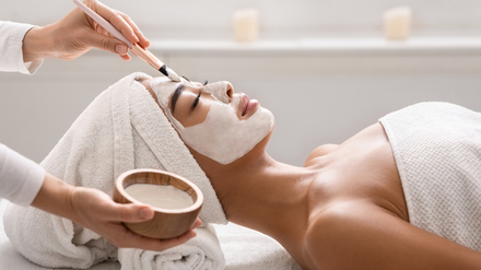 A woman is getting a facial treatment at a spa.