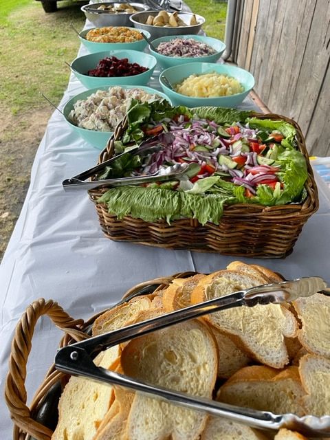 A Buffet Table With A Basket Of Bread And Bowls Of Food — Tru Blu Catering In Woolgoolga, NSW