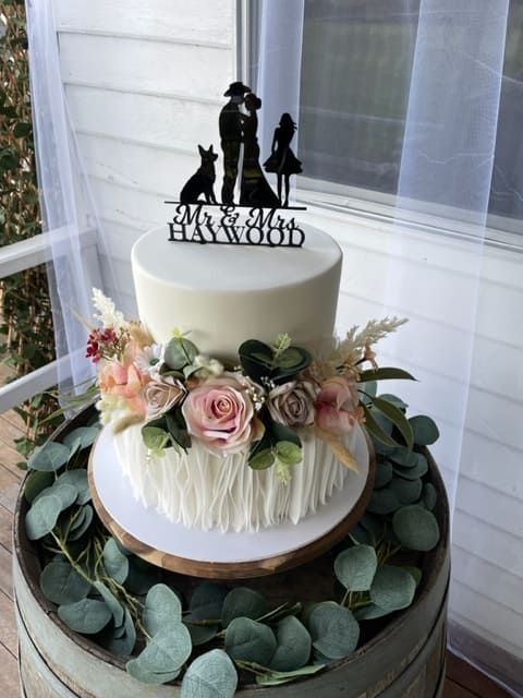 A Wedding Cake Is Sitting On Top Of A Wooden Barrel — Tru Blu Catering In Port Macquarie, NSW