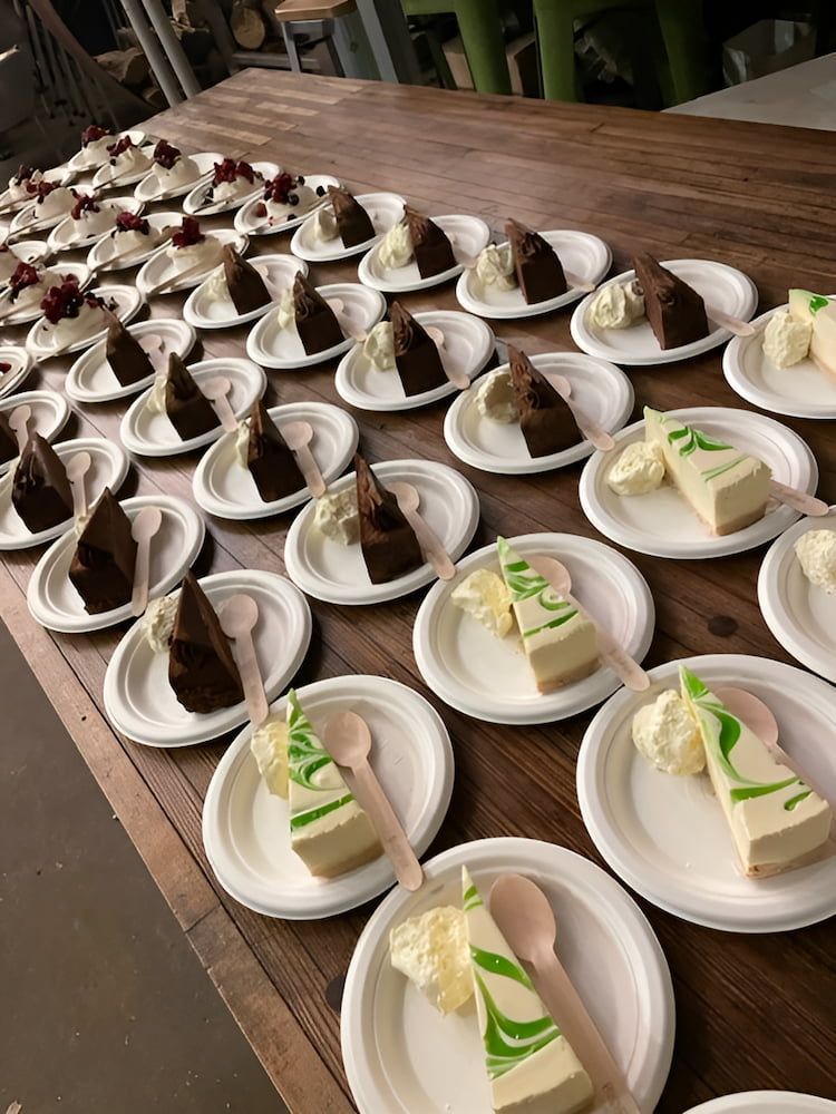 A Table Topped With Plates Of Desserts And Spoons — Tru Blu Catering In Port Macquarie, NSW