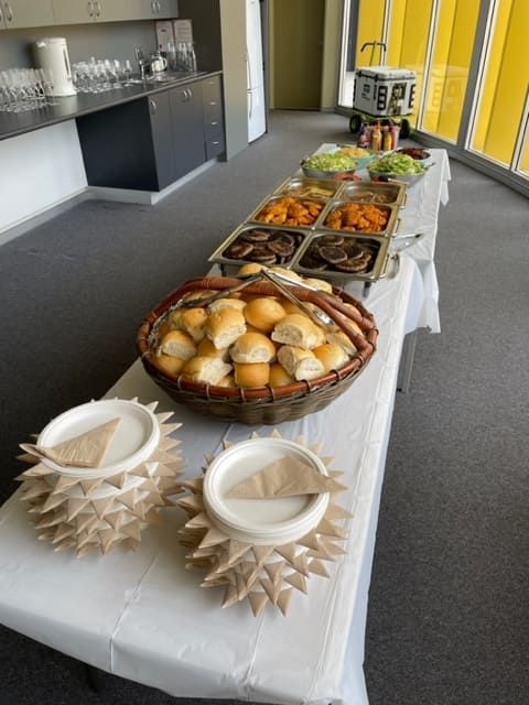 A Buffet Table With A Basket Of Rolls On It — Tru Blu Catering In Sawtell, NSW
