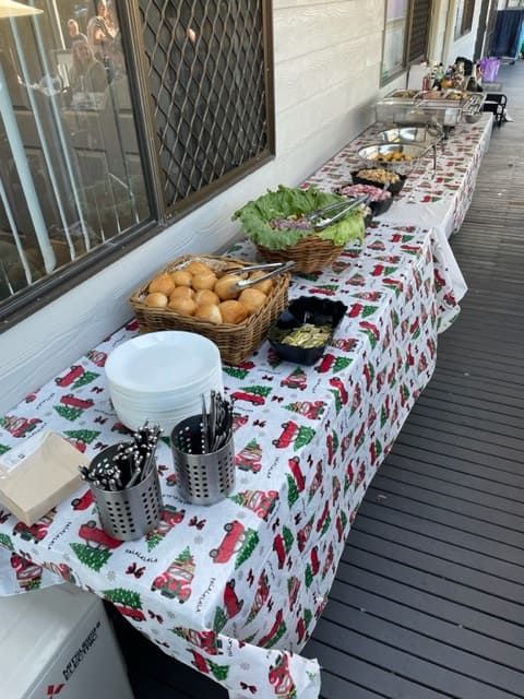 A Buffet Table With A Santa Claus Table Cloth — Tru Blu Catering In Sawtell, NSW