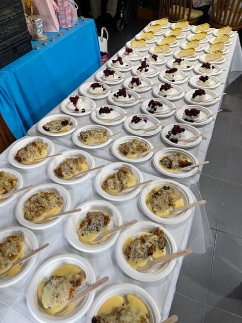A Table Full Of Plates Of Food With Spoons On Them — Tru Blu Catering In Coffs Harbour, NSW