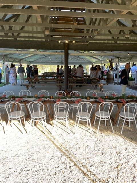 A Group Of People Are Standing Around Tables And Chairs Under A Tent — Tru Blu Catering In Nambucca, NSW