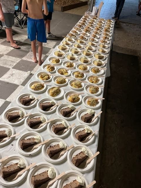 A Long Table With Many Plates Of Food On It — Tru Blu Catering In Taree, NSW