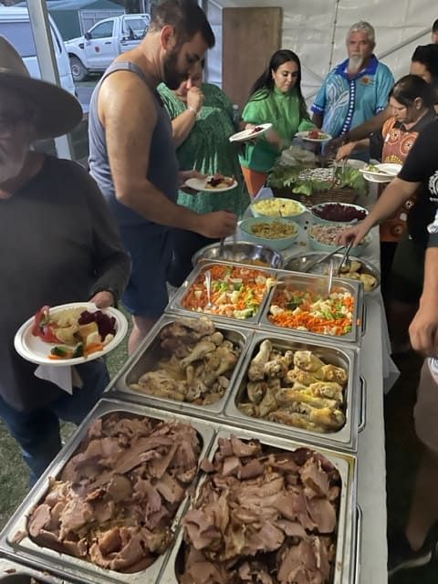 A Group Of People Are Standing Around A Table Filled With Food — Tru Blu Catering In Wauchope, NSW