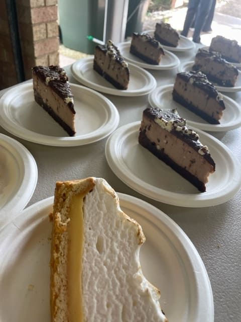 A Slice Of Cheesecake Is On A Plate Next To Other Slices Of Cheesecake — Tru Blu Catering In Port Macquarie, NSW