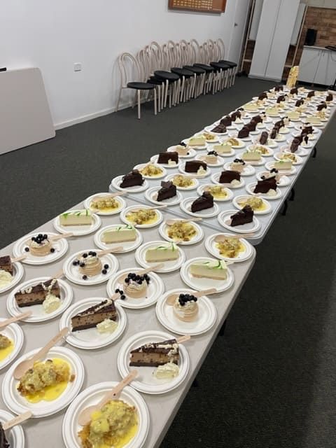 A Long Table With Many Plates Of Food On It — Tru Blu Catering In Port Macquarie, NSW