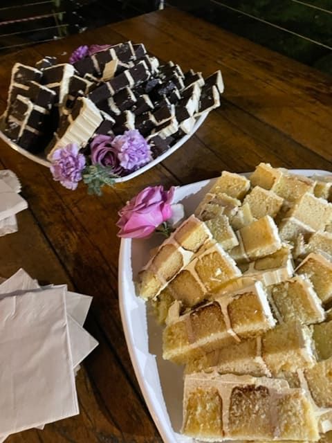 Two Plates Of Desserts Are On A Wooden Table — Tru Blu Catering In Port Macquarie, NSW
