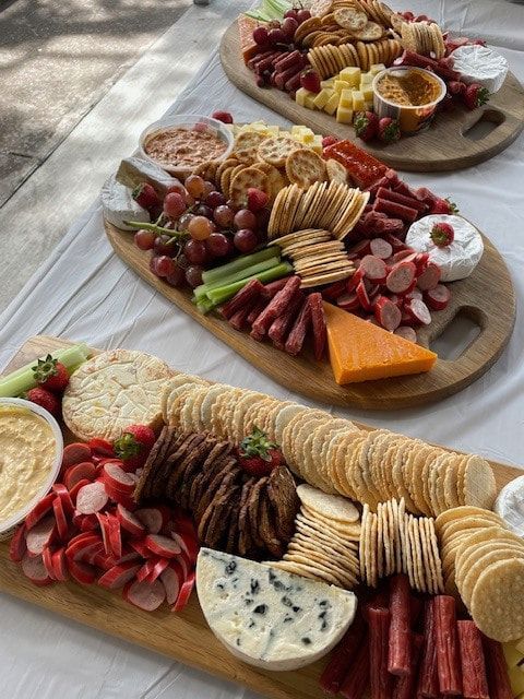 Three Wooden Boards Filled With Different Types Of Food On A Table — Tru Blu Catering In Taree, NSW