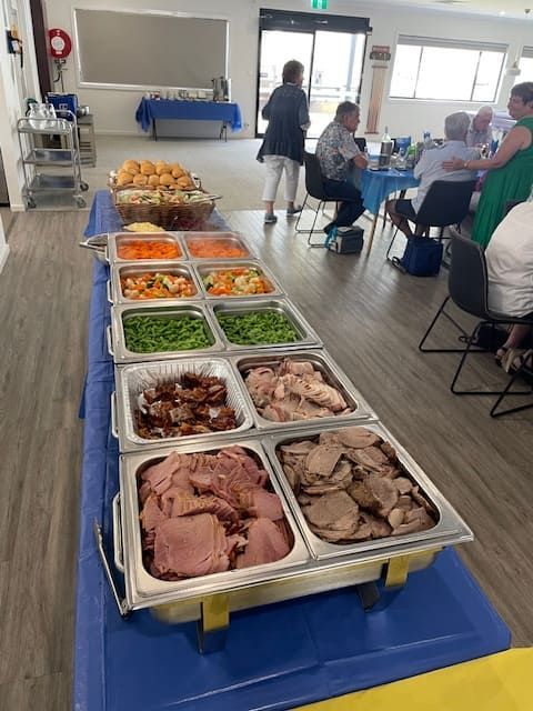 A Buffet Table With A Variety Of Food On It And People Sitting At Tables — Tru Blu Catering In Port Macquarie, NSW