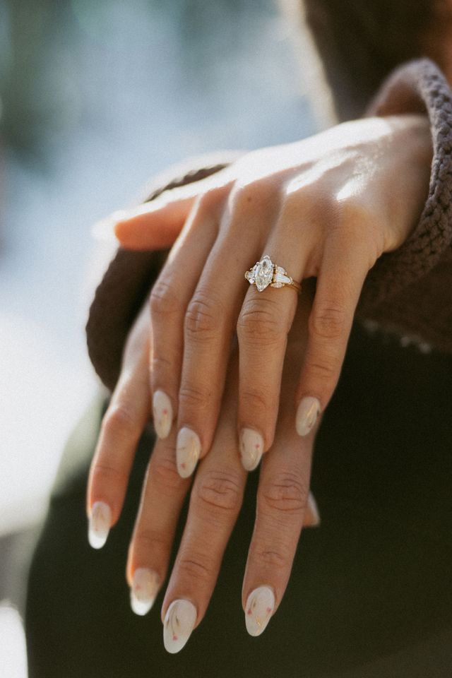 Jeweler setting a diamond into a white-gold solitaire ring