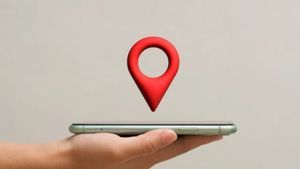 A hand holding a thin smartphone with a large, 3D red location map pin floating above the screen.
