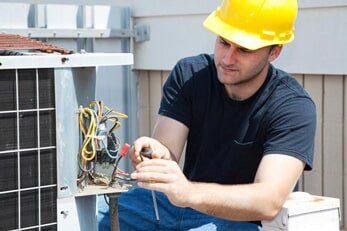 Man Repairing Air Condition — Air Conditioning in Saginaw, MI