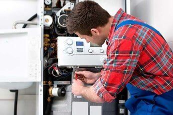 Technician Servicing Heating Boiler — Air Conditioning in Saginaw, MI