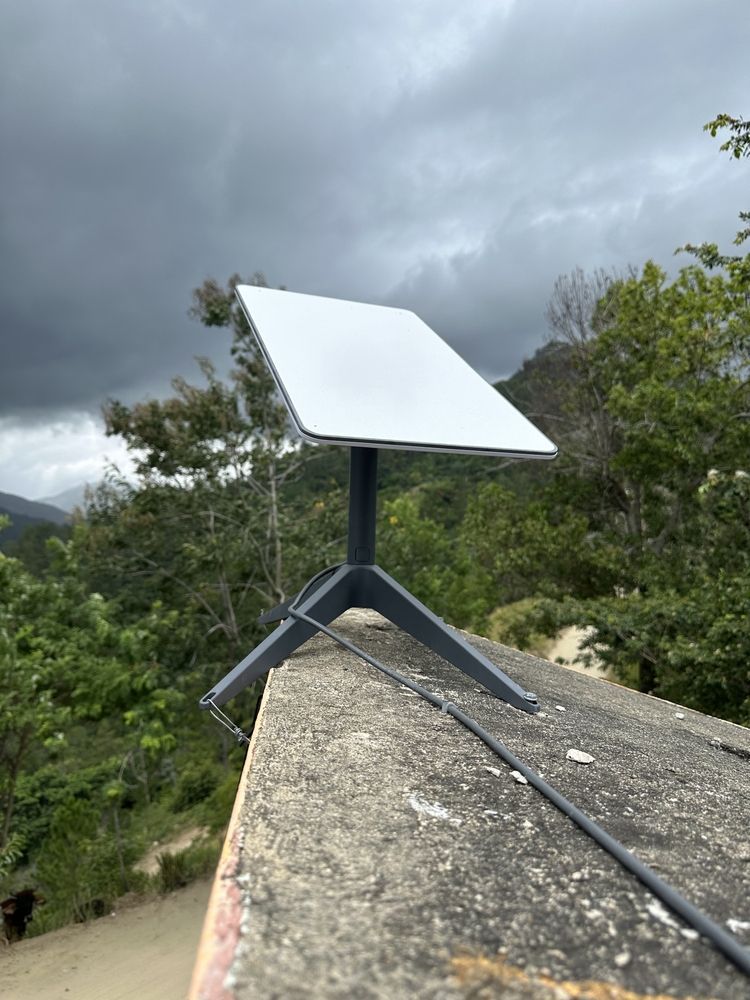 Starlink on a Roof Against Cloudy Sky, Surrounded by Green Trees — MATV Systems Australia Pty Ltd in Wickham, NSW