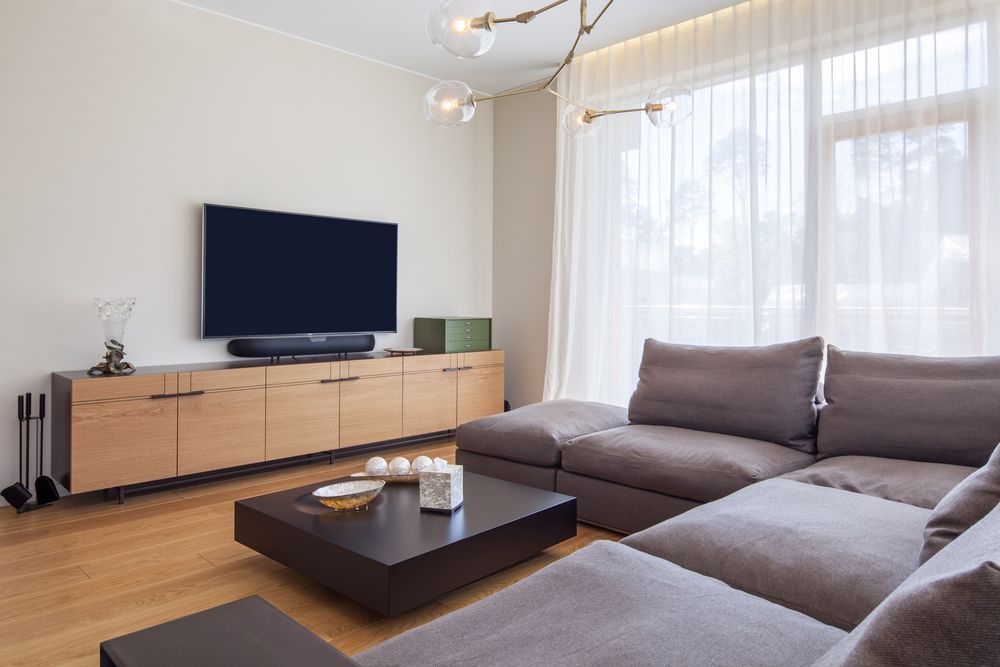 Modern Living Room With TV on Wooden Stand — MATV Systems Australia Pty Ltd in Wickham, NSW