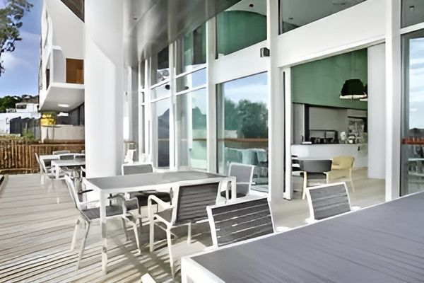 A Patio with Tables and Chairs in Front of A Building — MATV Systems Australia in Mayfield, NSW