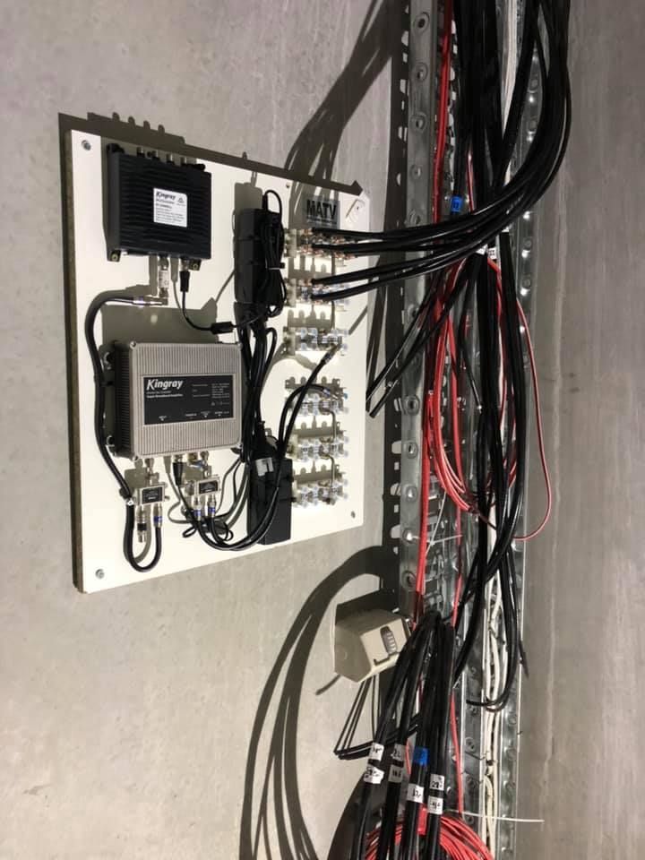 Electrical and Network Wiring Panel With Black Cables and Control Boxes — MATV Systems Australia Pty Ltd in Wickham, NSW