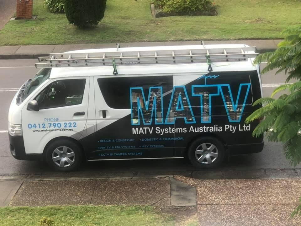 A White Van with The Word MATV on The Side Is Parked on The Side of The Road — MATV Systems Australia Pty Ltd in Wickham, NSW