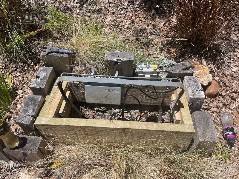 A Wooden Box Is Sitting in The Middle of A Field — MATV Systems Australia Pty Ltd in Coffs Harbour, ACT