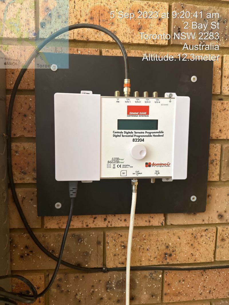 A White Device Is Attached to A Brick Wall — MATV Systems Australia Pty Ltd in Hunter Valley, NSW