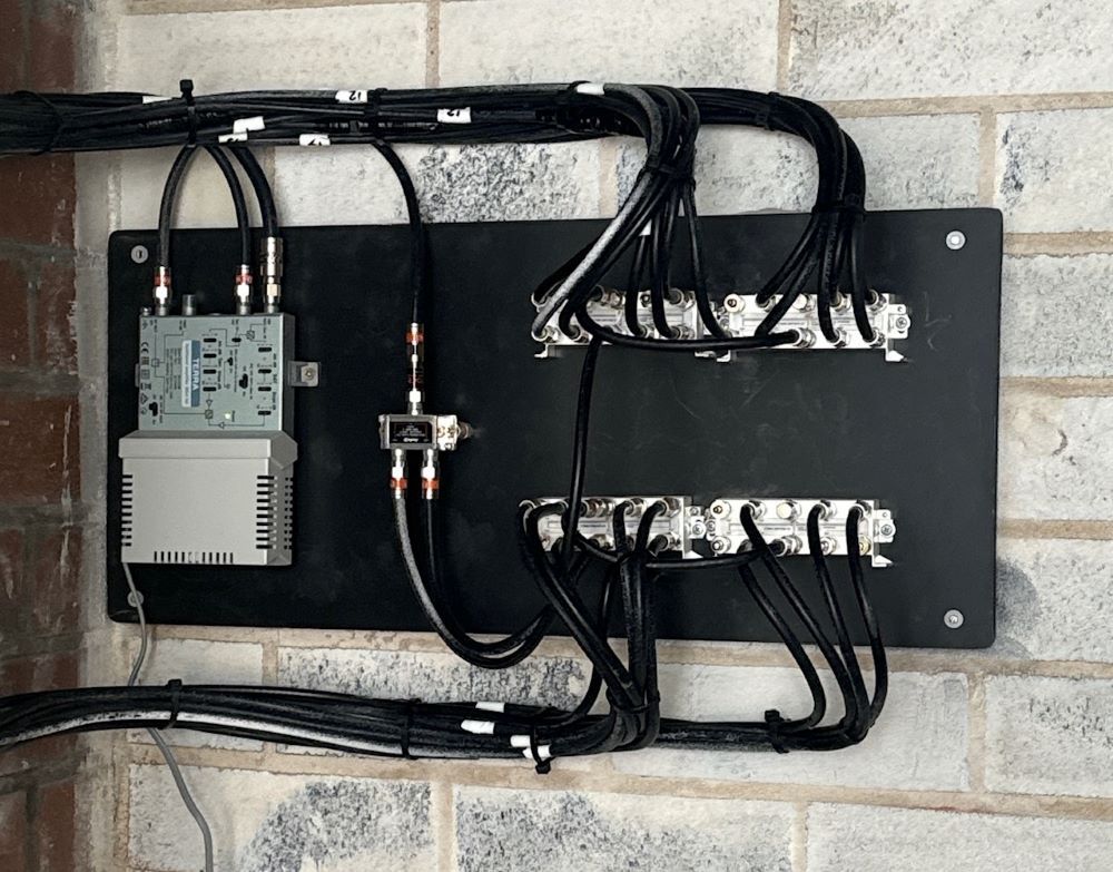 A Bunch of Wires Are Connected to A Brick Wall — MATV Systems Australia in Mayfield, NSW