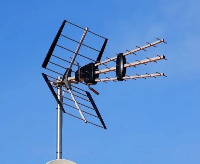 TV antenna mounted on a pole against a clear blue sky — MATV Systems Australia Pty Ltd in Wickham, NSW